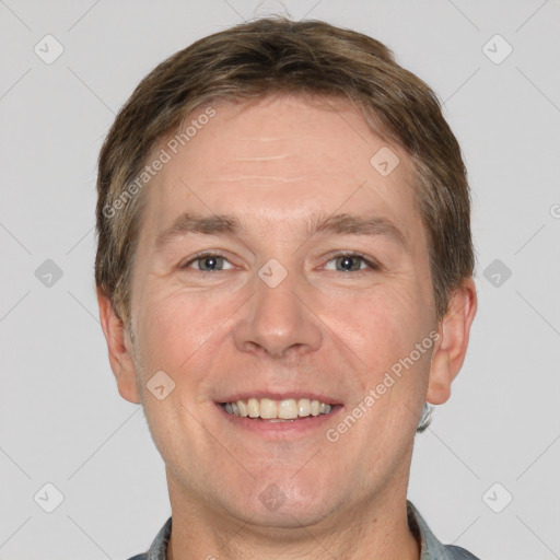 Joyful white adult male with short  brown hair and grey eyes