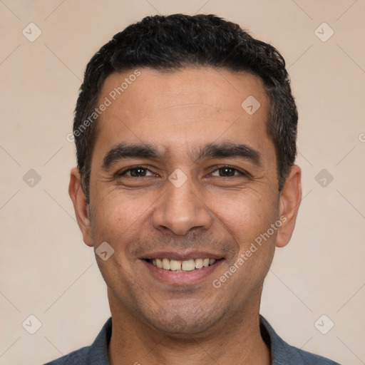 Joyful white young-adult male with short  black hair and brown eyes
