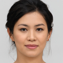 Joyful asian young-adult female with medium  brown hair and brown eyes