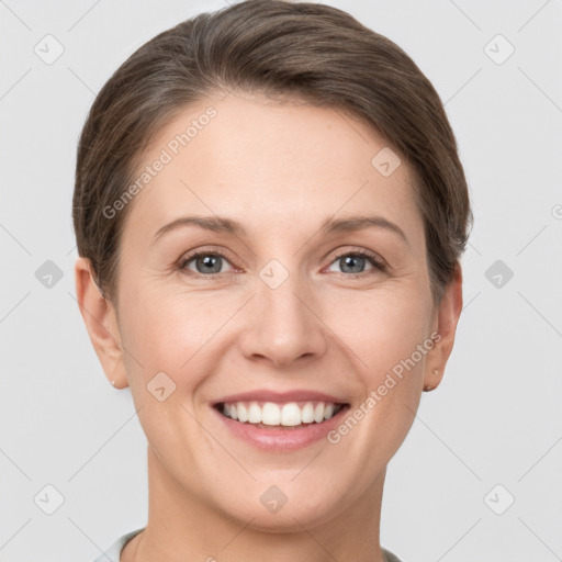 Joyful white young-adult female with short  brown hair and grey eyes