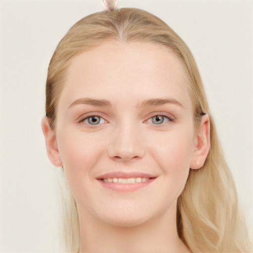 Joyful white young-adult female with long  brown hair and blue eyes