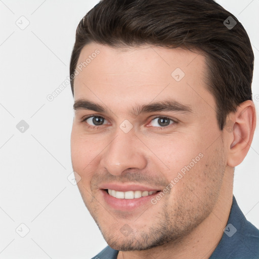 Joyful white young-adult male with short  brown hair and brown eyes