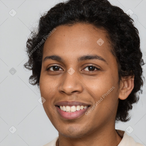 Joyful black young-adult female with short  brown hair and brown eyes