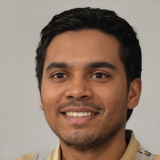 Joyful latino young-adult male with short  black hair and brown eyes