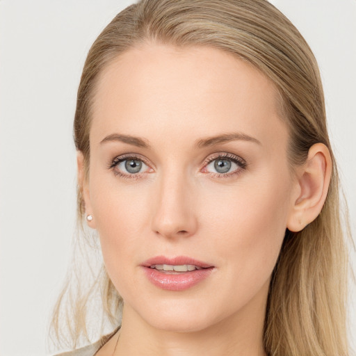 Joyful white young-adult female with long  brown hair and blue eyes