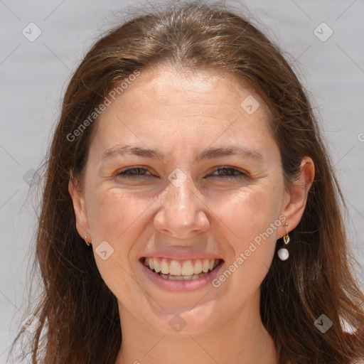 Joyful white adult female with long  brown hair and brown eyes