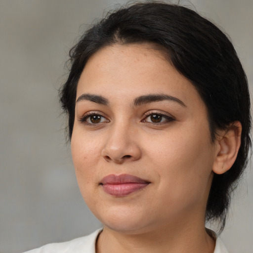 Joyful latino young-adult female with medium  black hair and brown eyes