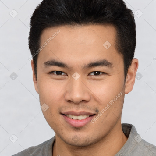 Joyful asian young-adult male with short  brown hair and brown eyes