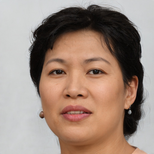 Joyful asian adult female with medium  brown hair and brown eyes