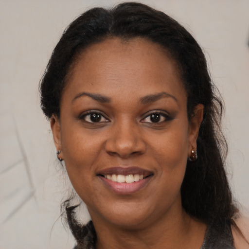 Joyful black young-adult female with medium  brown hair and brown eyes
