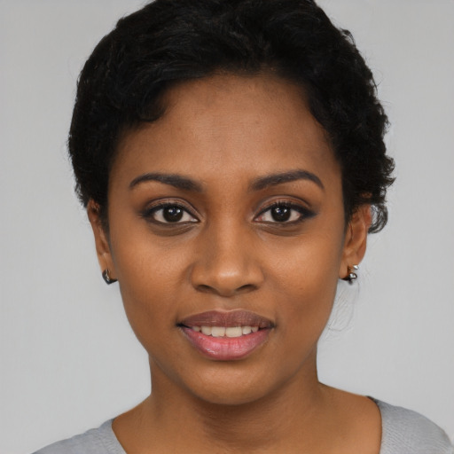 Joyful black young-adult female with short  black hair and brown eyes