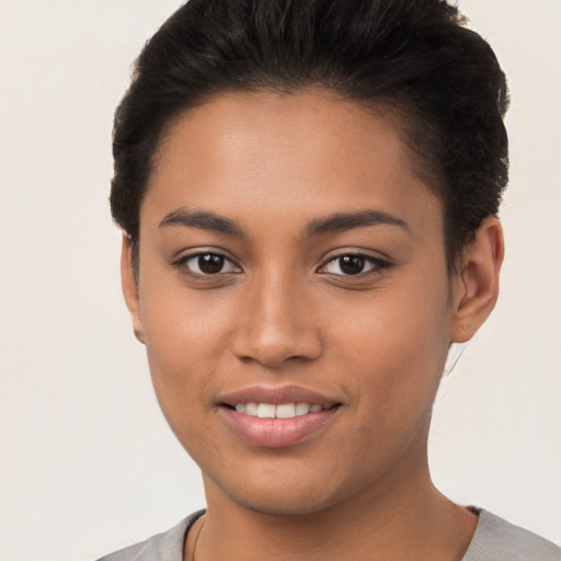 Joyful latino young-adult female with short  brown hair and brown eyes