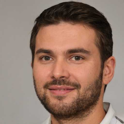 Joyful white young-adult male with short  brown hair and brown eyes