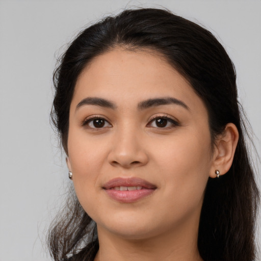 Joyful latino young-adult female with long  brown hair and brown eyes