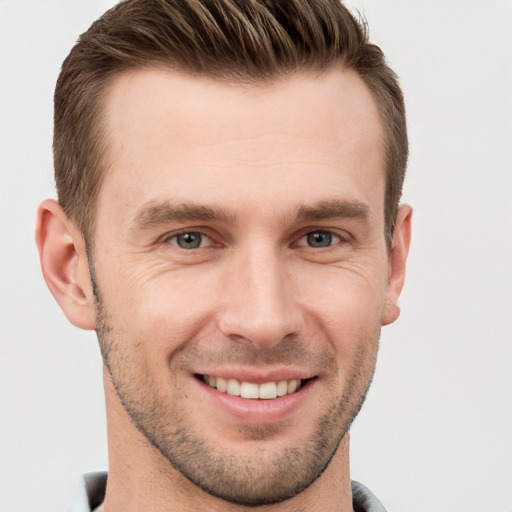 Joyful white young-adult male with short  brown hair and brown eyes