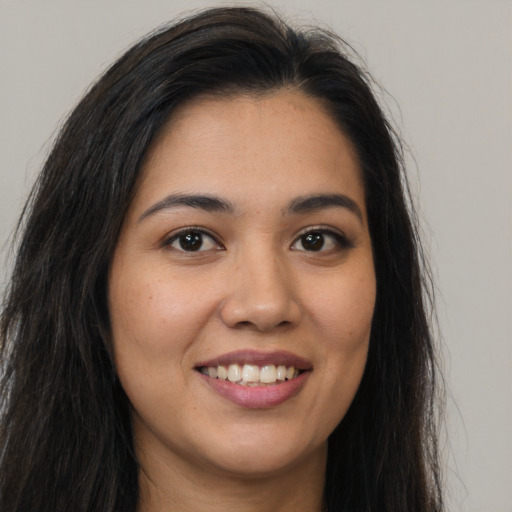 Joyful asian young-adult female with long  brown hair and brown eyes