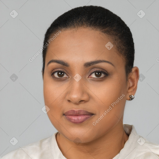 Joyful black young-adult female with short  black hair and brown eyes