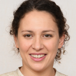 Joyful white young-adult female with medium  brown hair and brown eyes