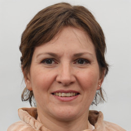 Joyful white adult female with medium  brown hair and brown eyes