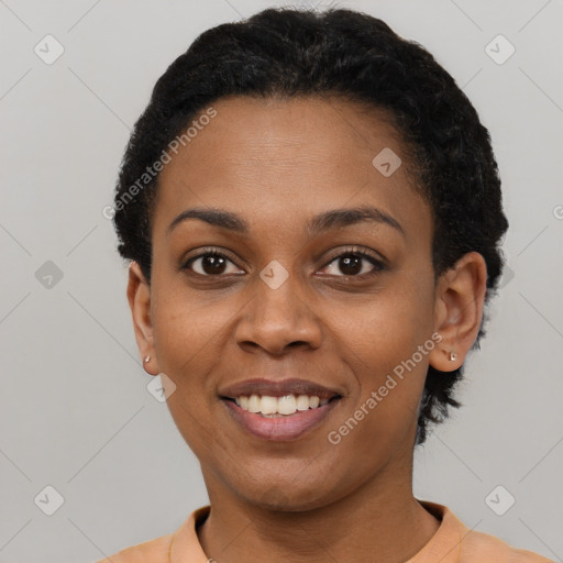 Joyful black young-adult female with short  black hair and brown eyes