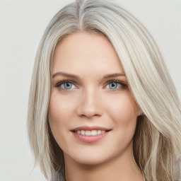 Joyful white young-adult female with long  brown hair and blue eyes