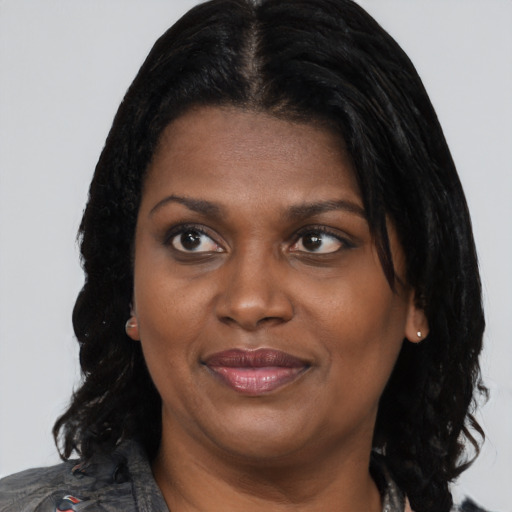 Joyful black young-adult female with medium  black hair and brown eyes