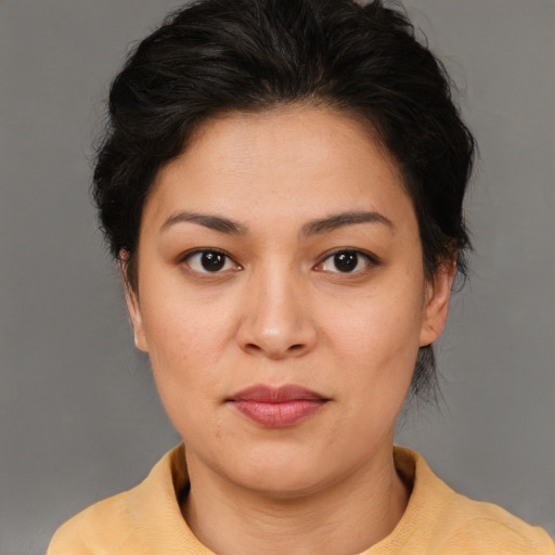Joyful asian young-adult female with short  brown hair and brown eyes