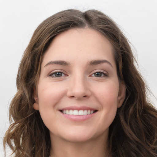 Joyful white young-adult female with long  brown hair and grey eyes