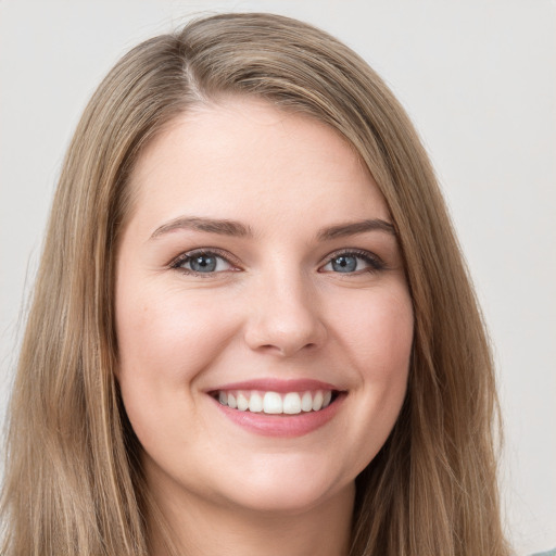 Joyful white young-adult female with long  brown hair and grey eyes