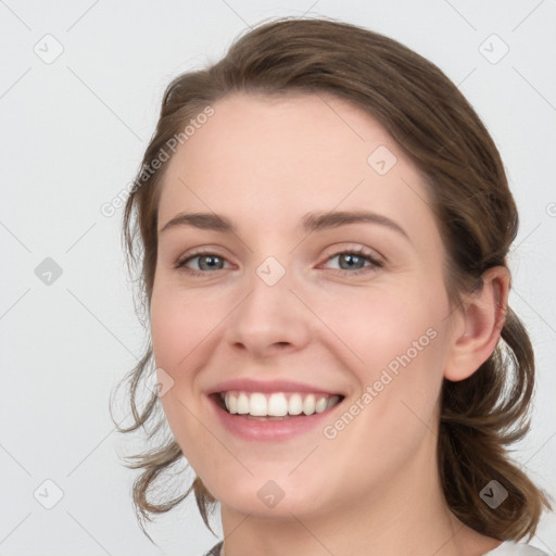 Joyful white young-adult female with medium  brown hair and blue eyes