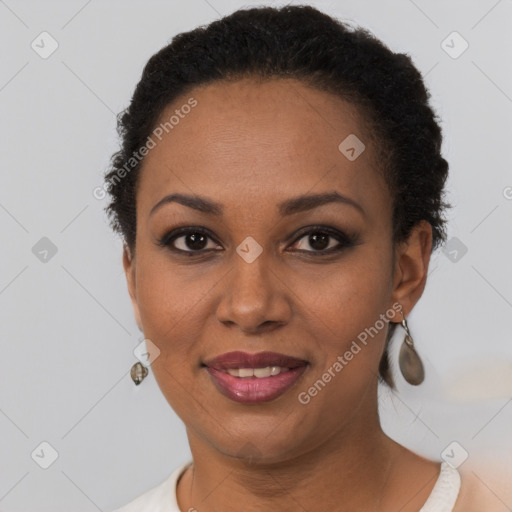 Joyful black young-adult female with short  brown hair and brown eyes