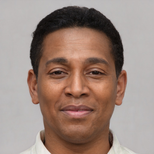 Joyful latino adult male with short  brown hair and brown eyes