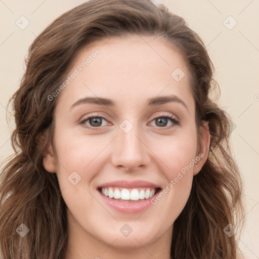 Joyful white young-adult female with long  brown hair and blue eyes