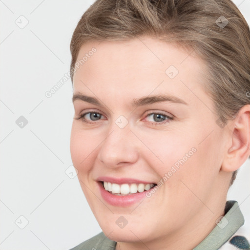 Joyful white young-adult female with short  brown hair and grey eyes