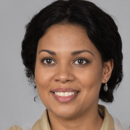 Joyful black adult female with medium  brown hair and brown eyes