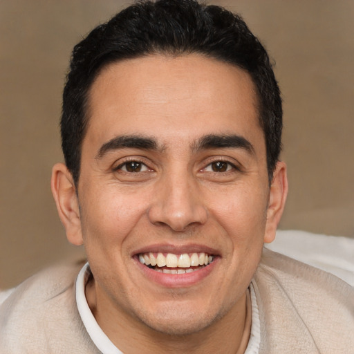 Joyful white young-adult male with short  black hair and brown eyes