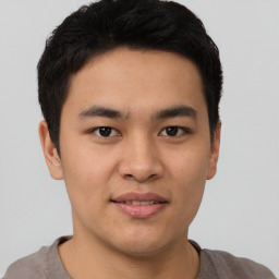 Joyful asian young-adult male with short  brown hair and brown eyes