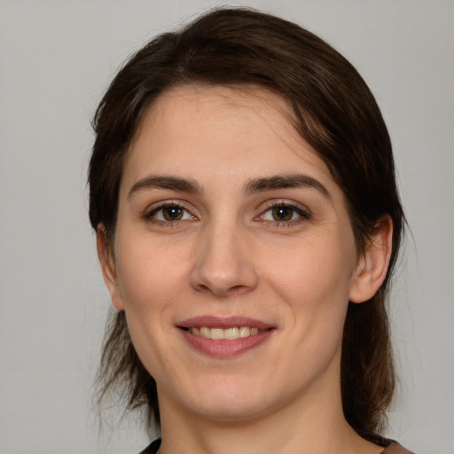 Joyful white young-adult female with medium  brown hair and brown eyes