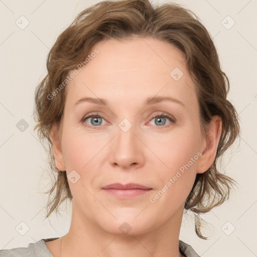 Joyful white adult female with medium  brown hair and blue eyes