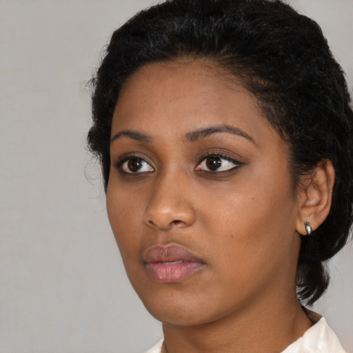 Neutral black young-adult female with short  black hair and brown eyes