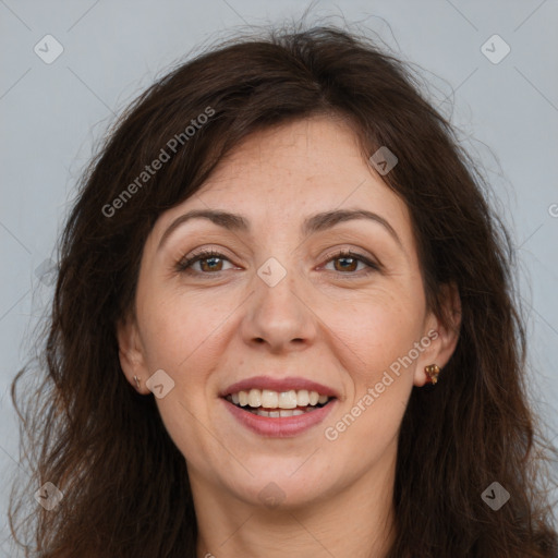 Joyful white adult female with long  brown hair and brown eyes