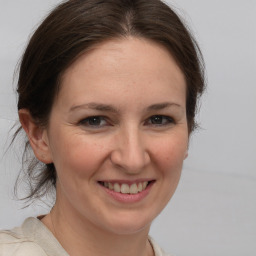 Joyful white adult female with medium  brown hair and brown eyes