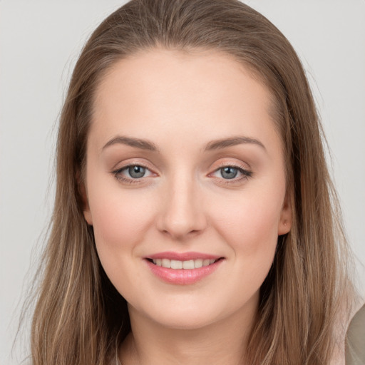 Joyful white young-adult female with long  brown hair and grey eyes