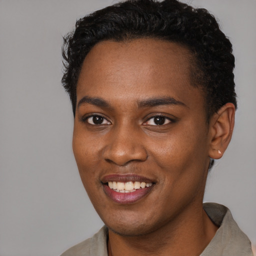 Joyful black young-adult female with short  black hair and brown eyes