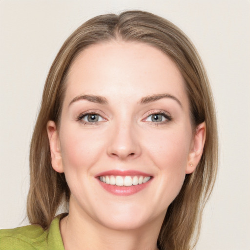 Joyful white young-adult female with medium  brown hair and blue eyes