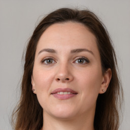 Joyful white young-adult female with medium  brown hair and grey eyes