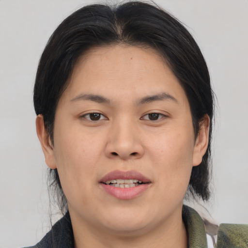 Joyful asian young-adult female with medium  brown hair and brown eyes
