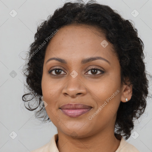 Joyful black young-adult female with long  brown hair and brown eyes