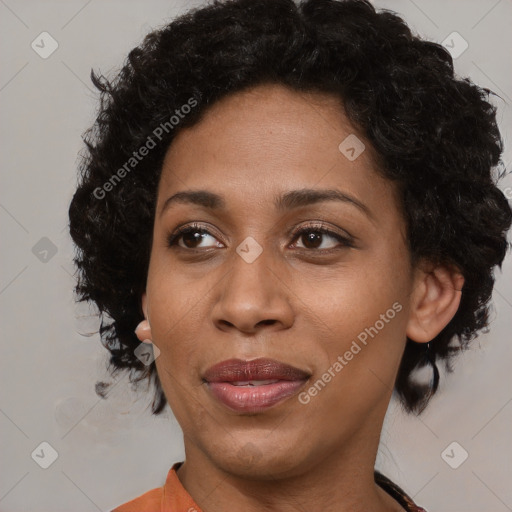 Joyful black adult female with medium  brown hair and brown eyes