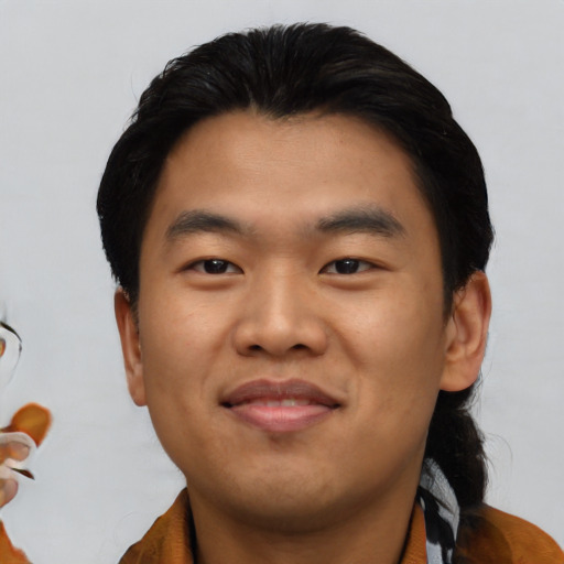 Joyful asian young-adult male with short  black hair and brown eyes